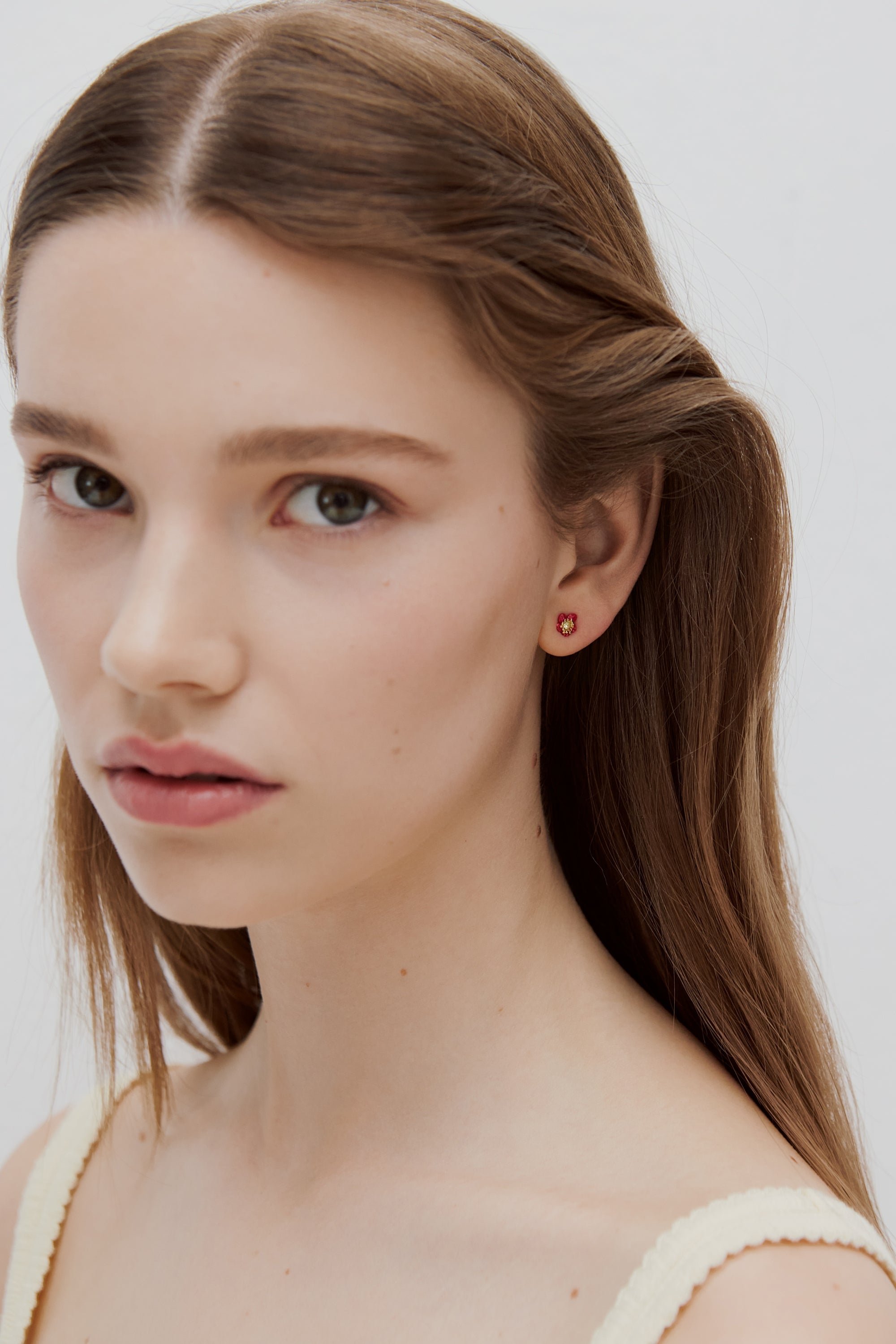 Single earring with a purple flower and a faceted stone