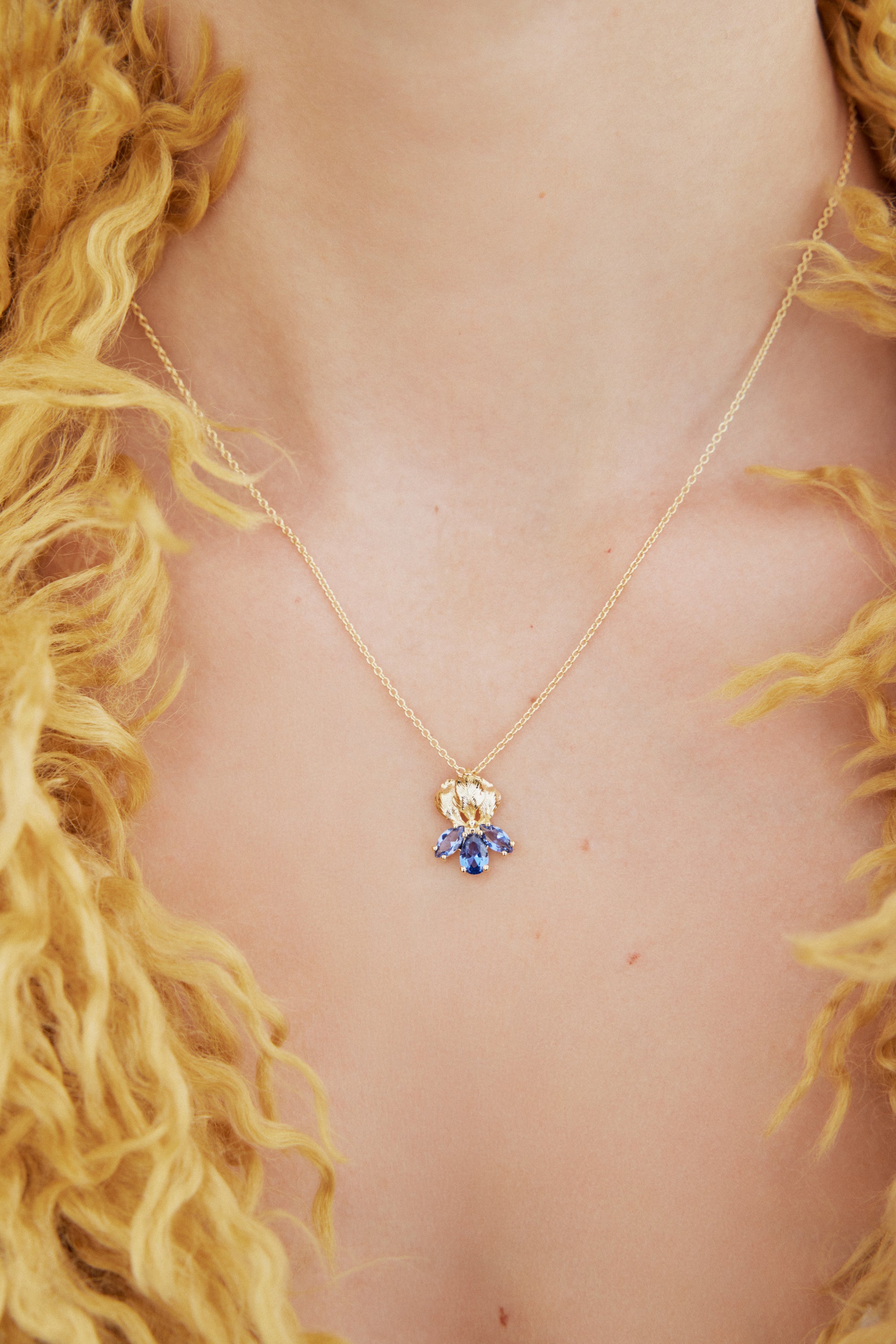 Golden iris and blue stone pendant necklace