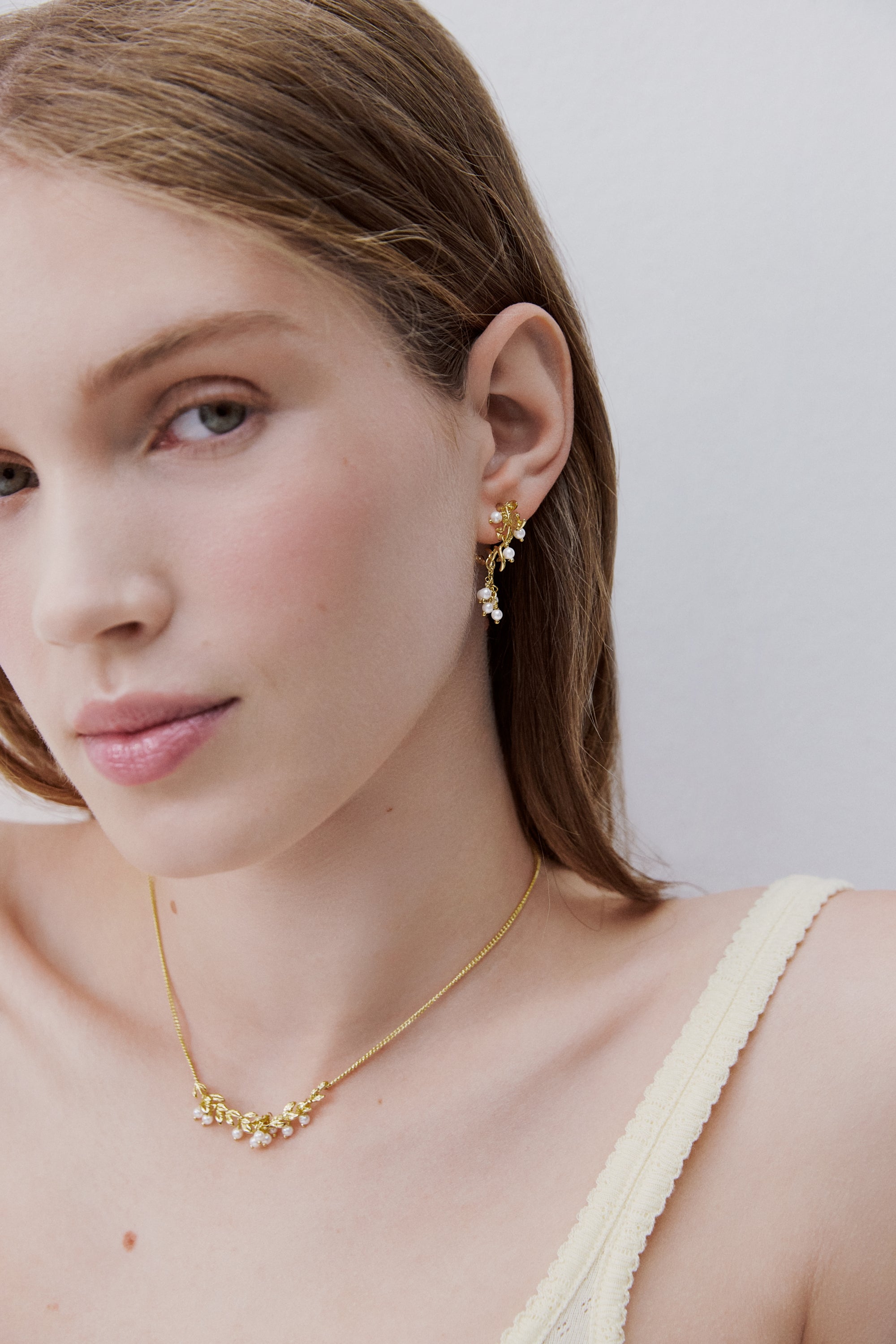 Gold and white post earrings with laurel arch and cultured pearls