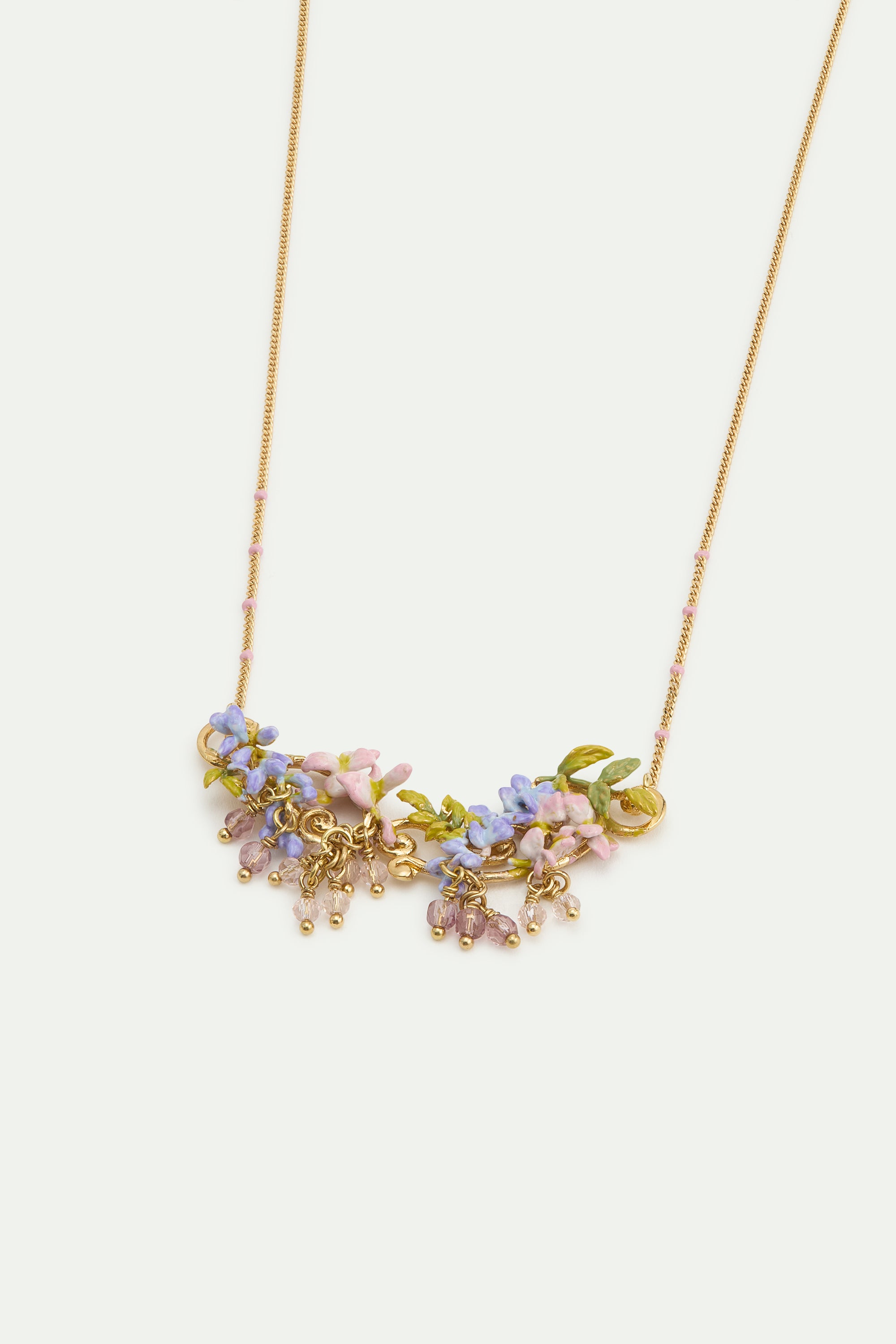 Statement necklace with pink and purple wisteria on a golden arabesque, adorned with ivy and dangling faceted pink and white crystal beads