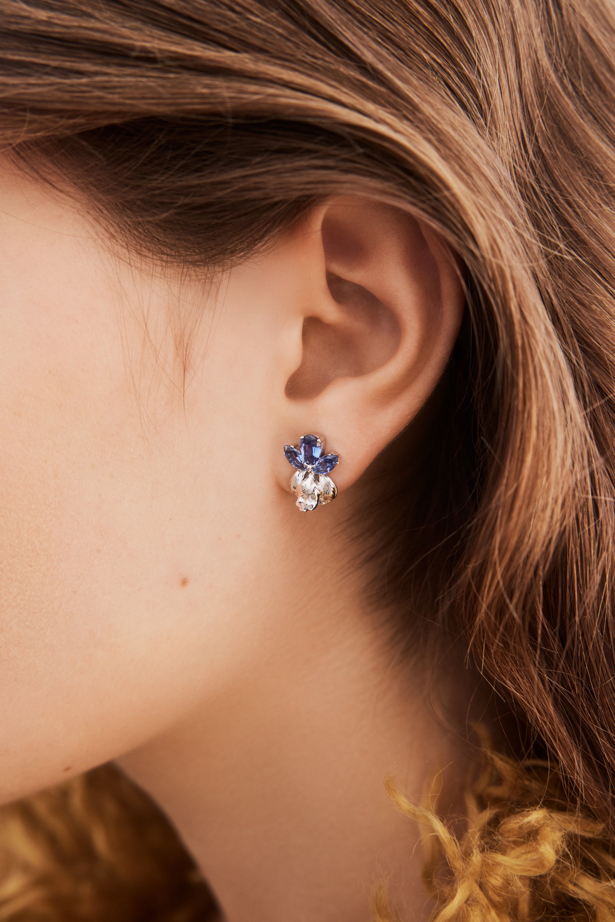 Silver iris and blue stone post earrings