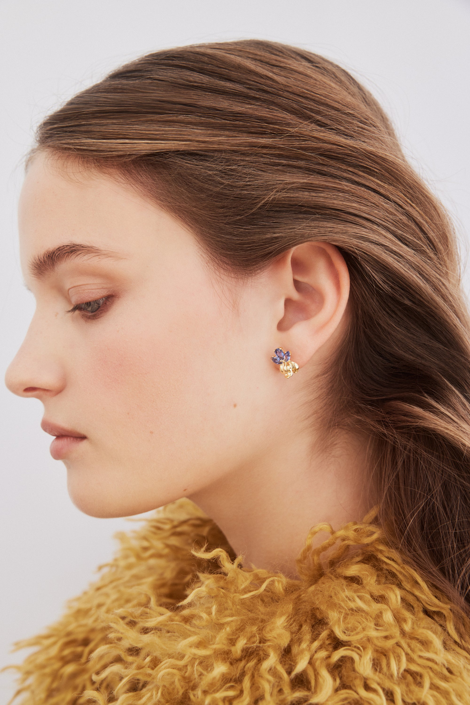 Golden iris and blue stone post earrings