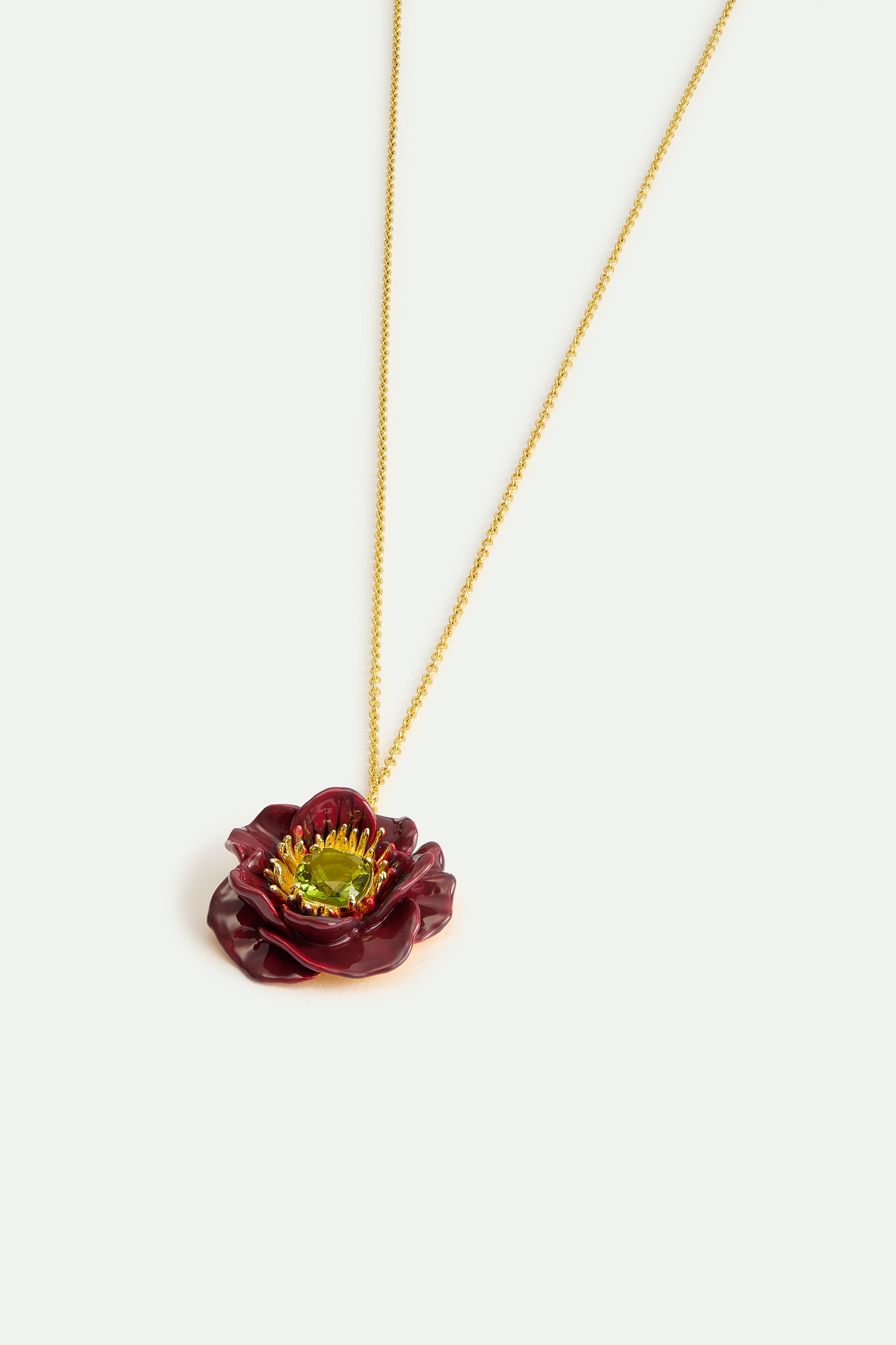 Pendant necklace with burgundy anemone flower and green faceted stone