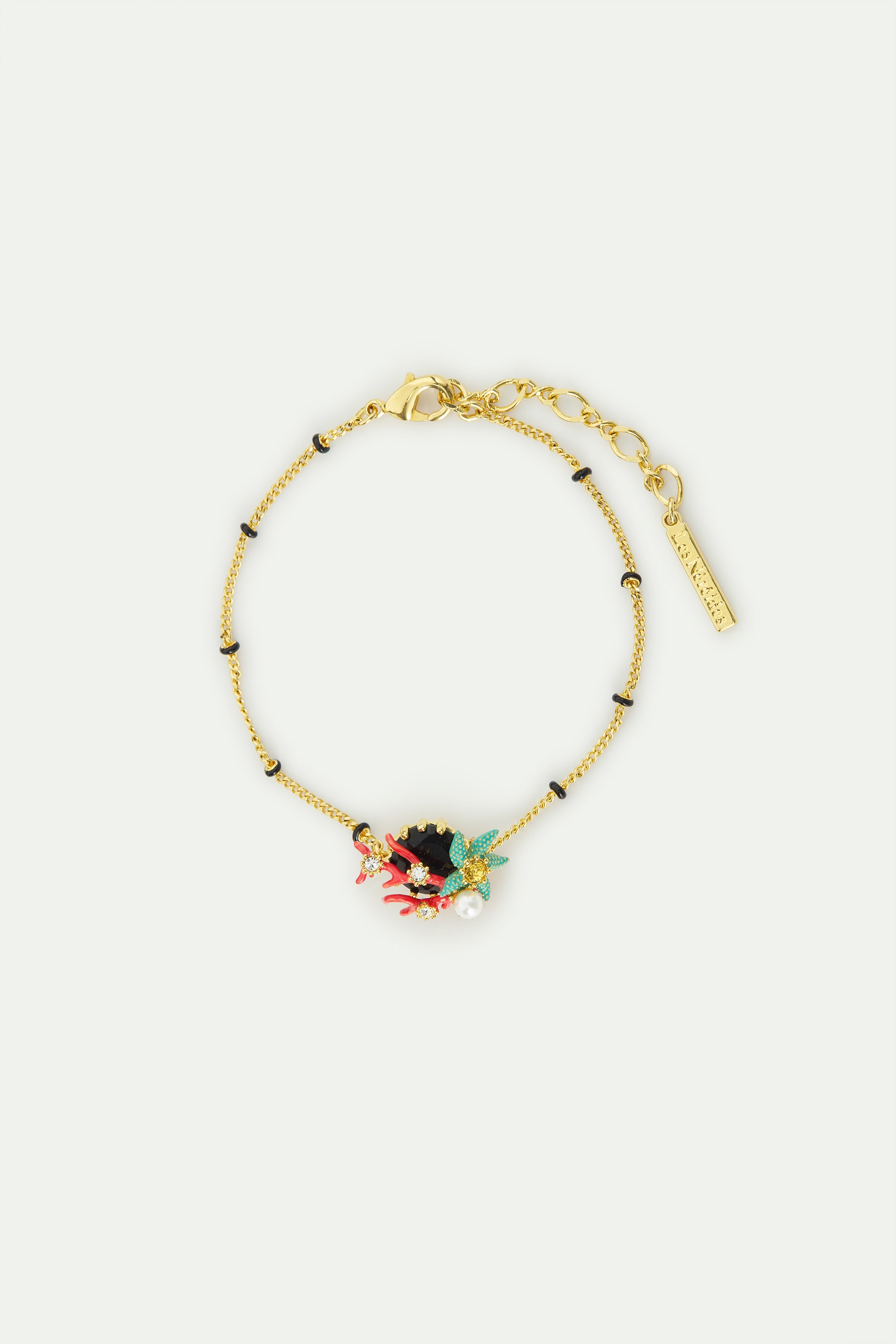 Fine bracelet with black round faceted stone, red coral, blue starfish and cultured pearl