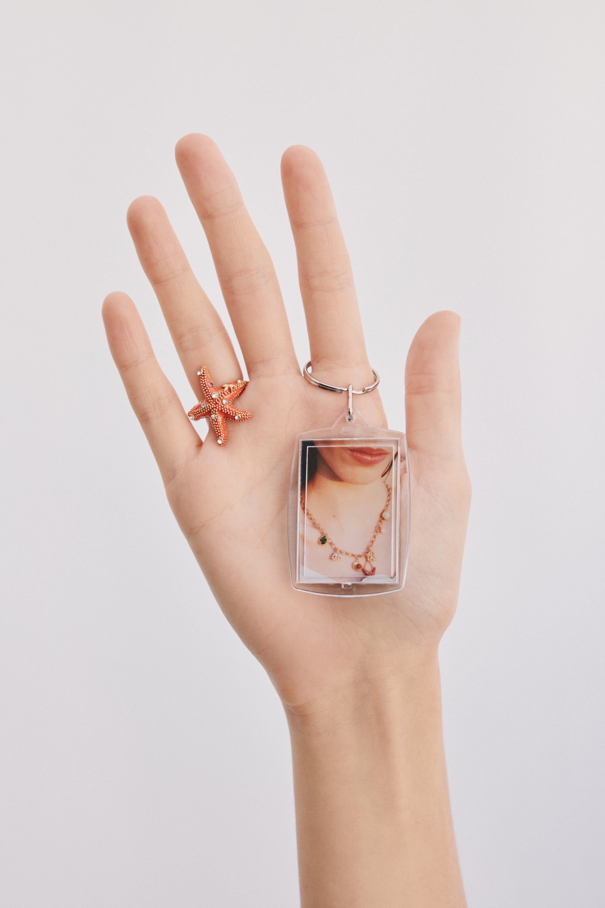 Adjustable orange starfish ring with multicoloured crystals