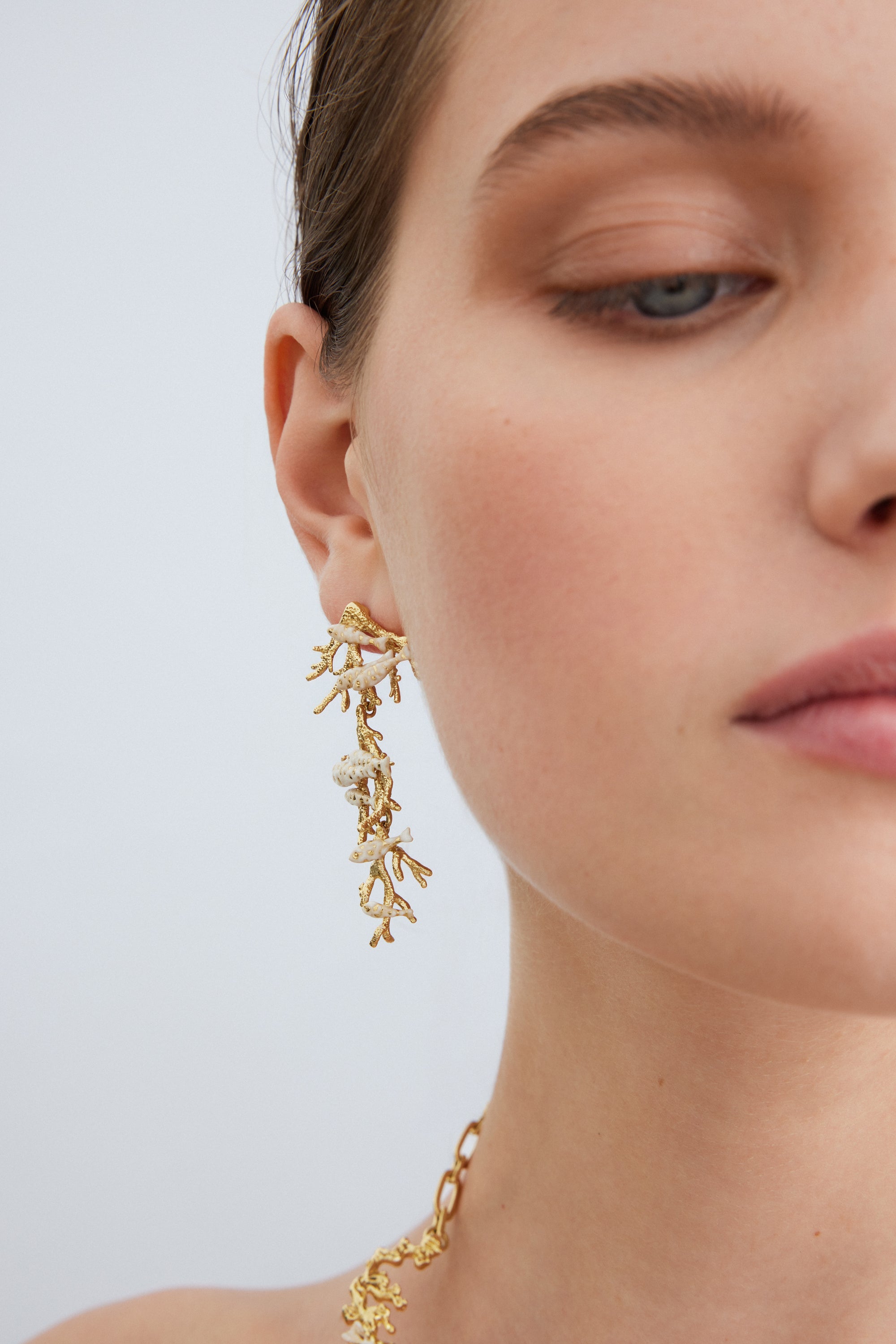 Golden coral and white fish dangle earrings
