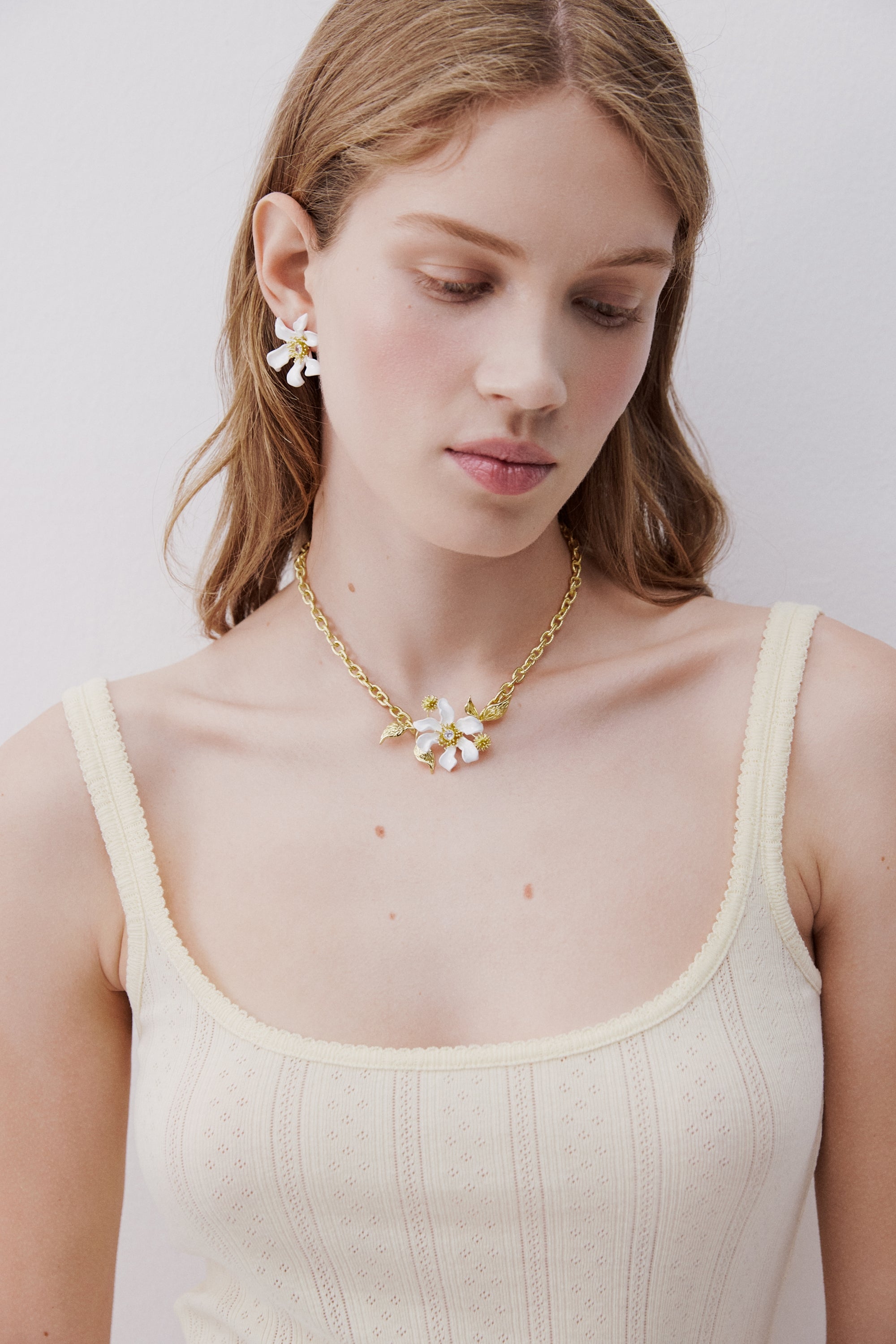 Large white clematis flower, Japanese kerria and laurel necklace