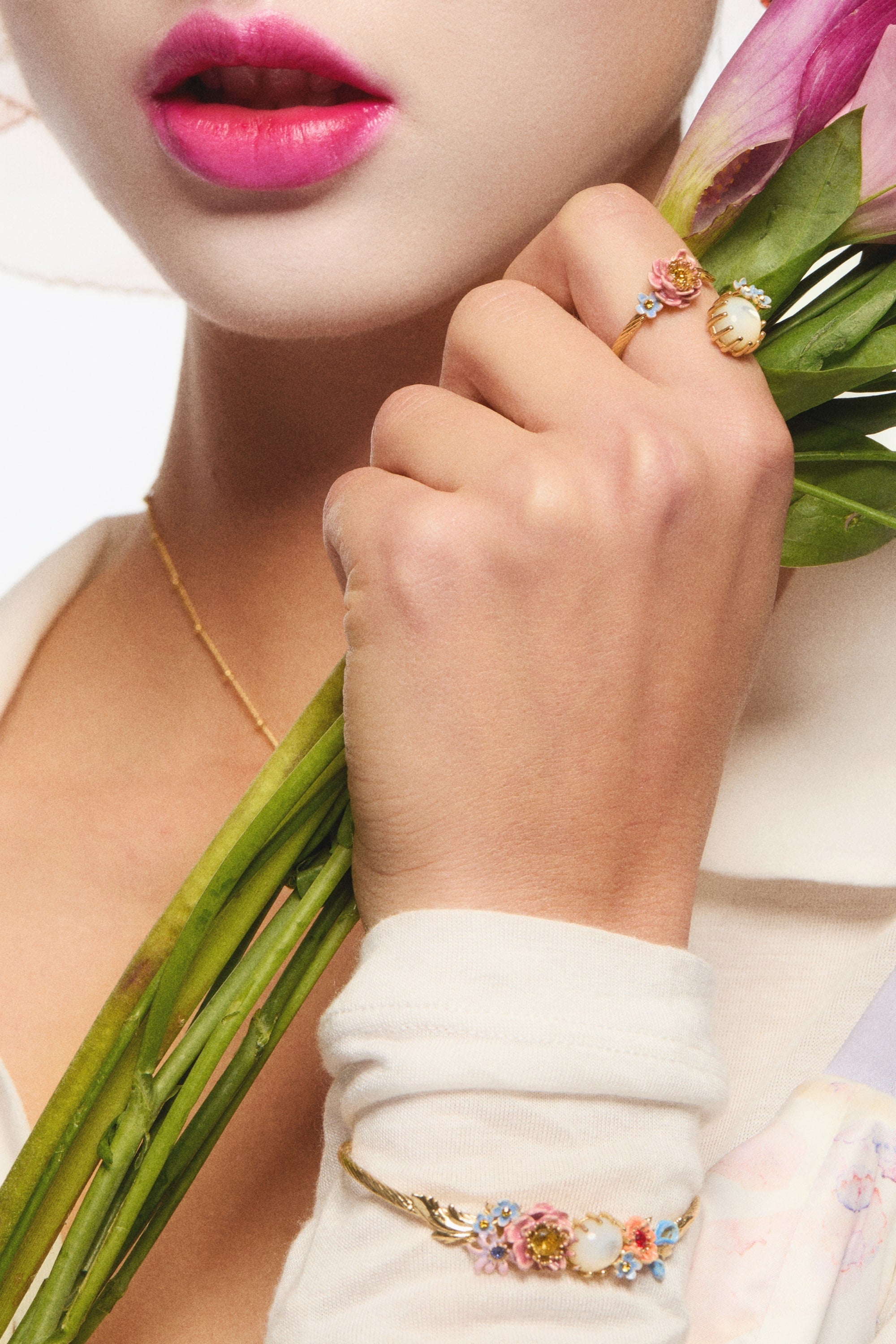 Bangle bracelet adorned with pink and blue flower and mother of pearl round stone