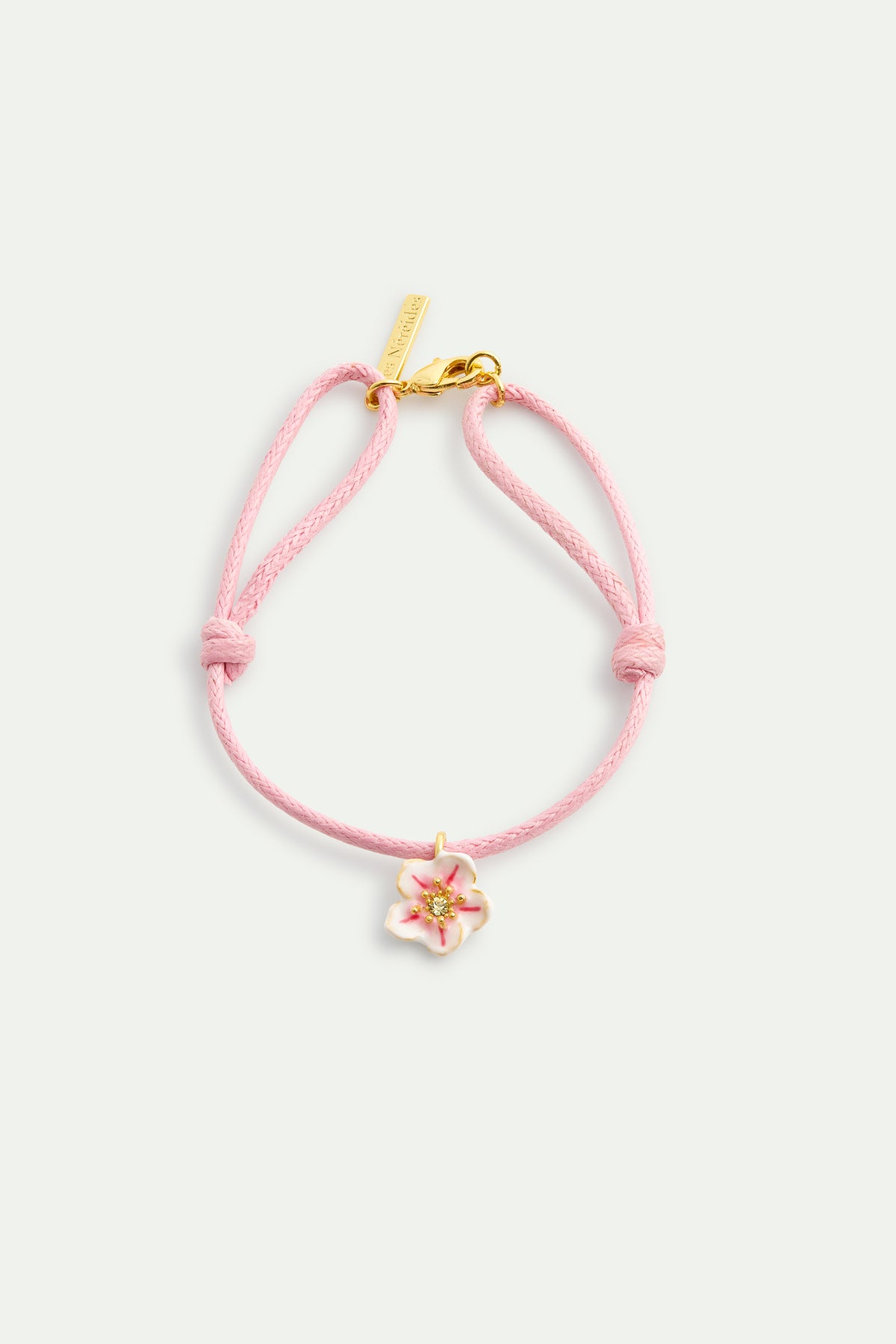 Pink thread bracelet with a tiny white cherry blossom