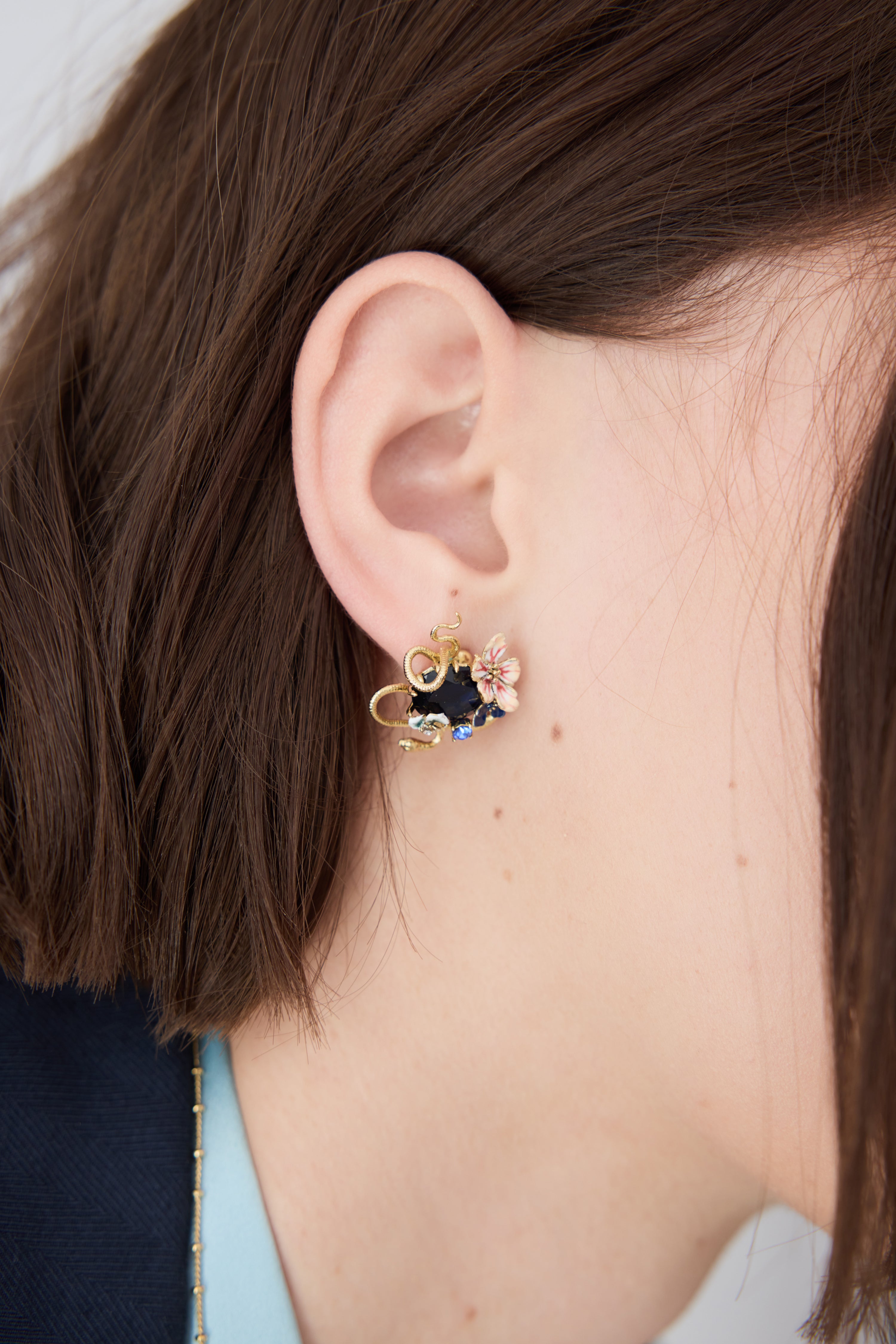 Earrings with blue faceted stone, gold snake and mallow flowers
