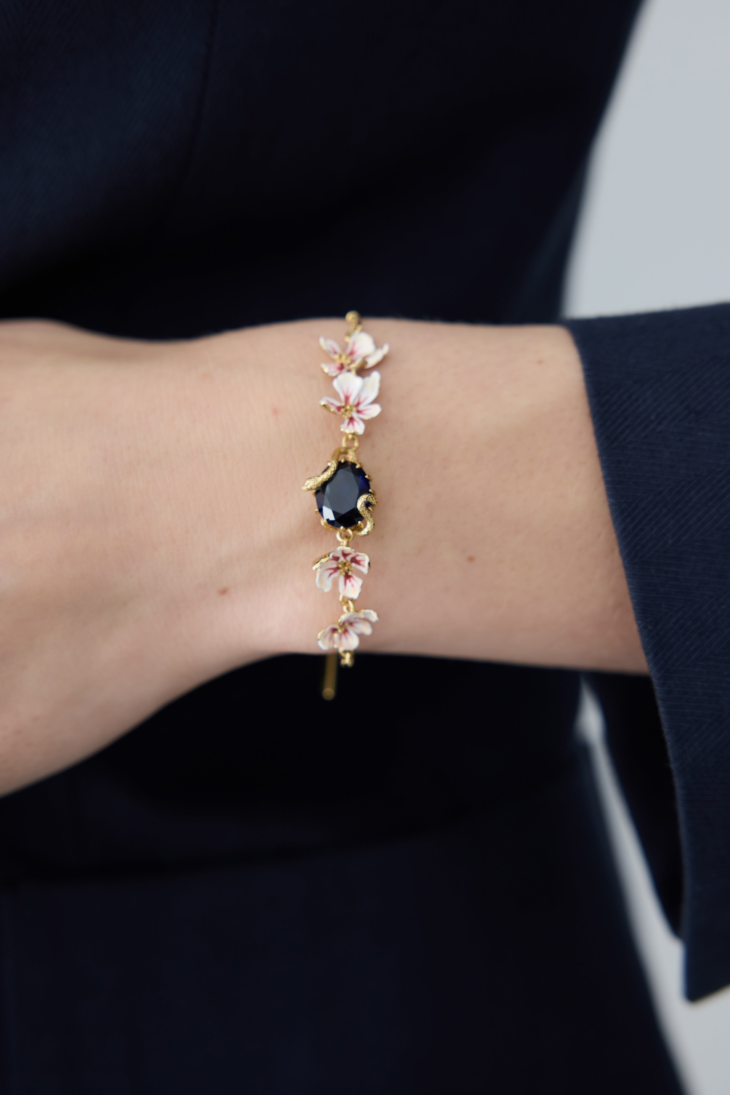 Bracelet with blue faceted stone, gold snake and mallow flowers
