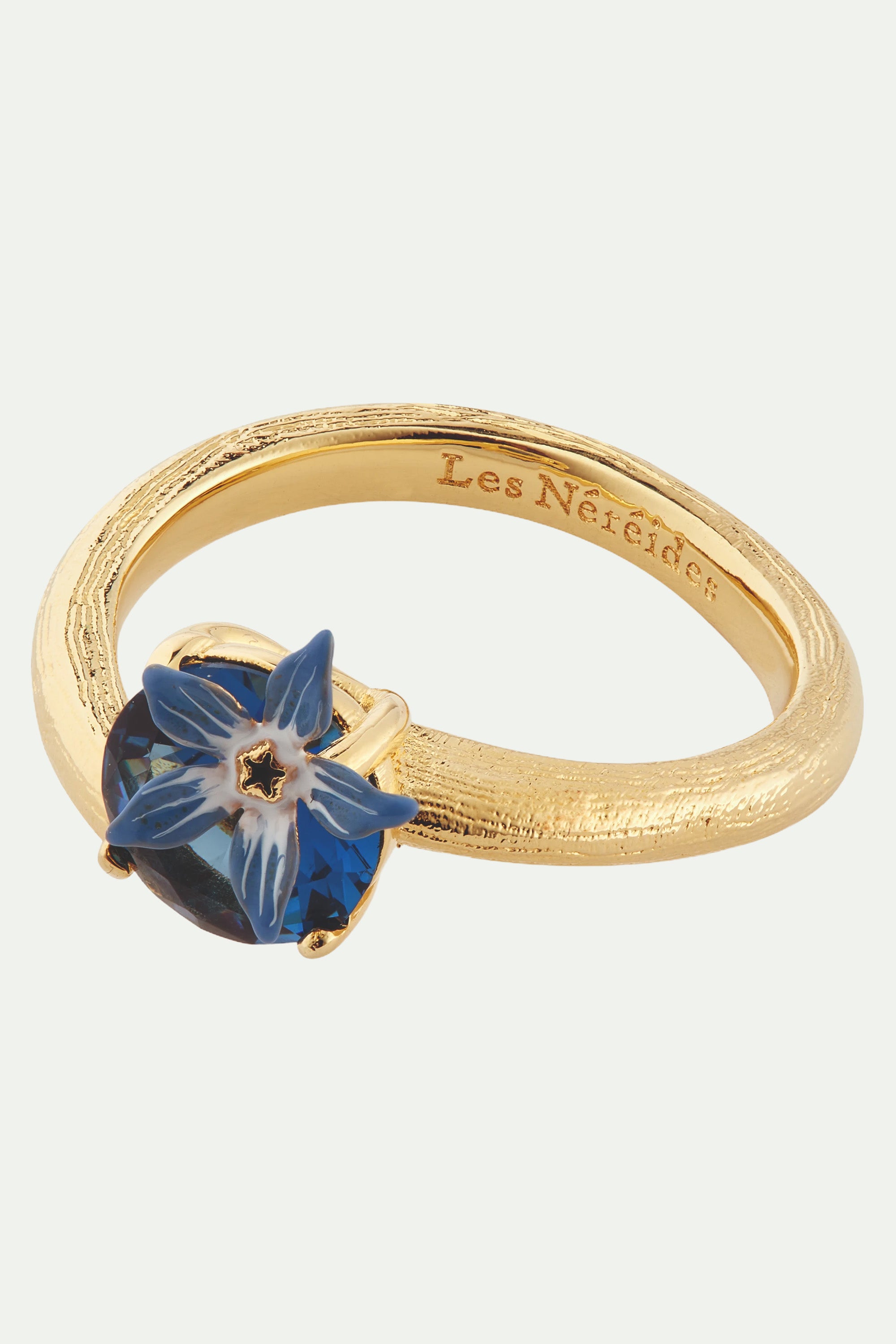 Anillo ajustable flor azul y cristal en facetas redondo