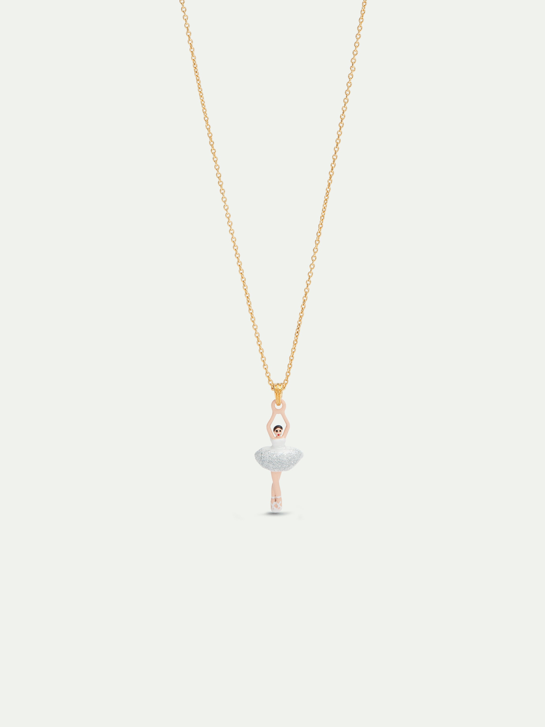 Ballerina wearing a white tutu with silver glitter pendant necklace