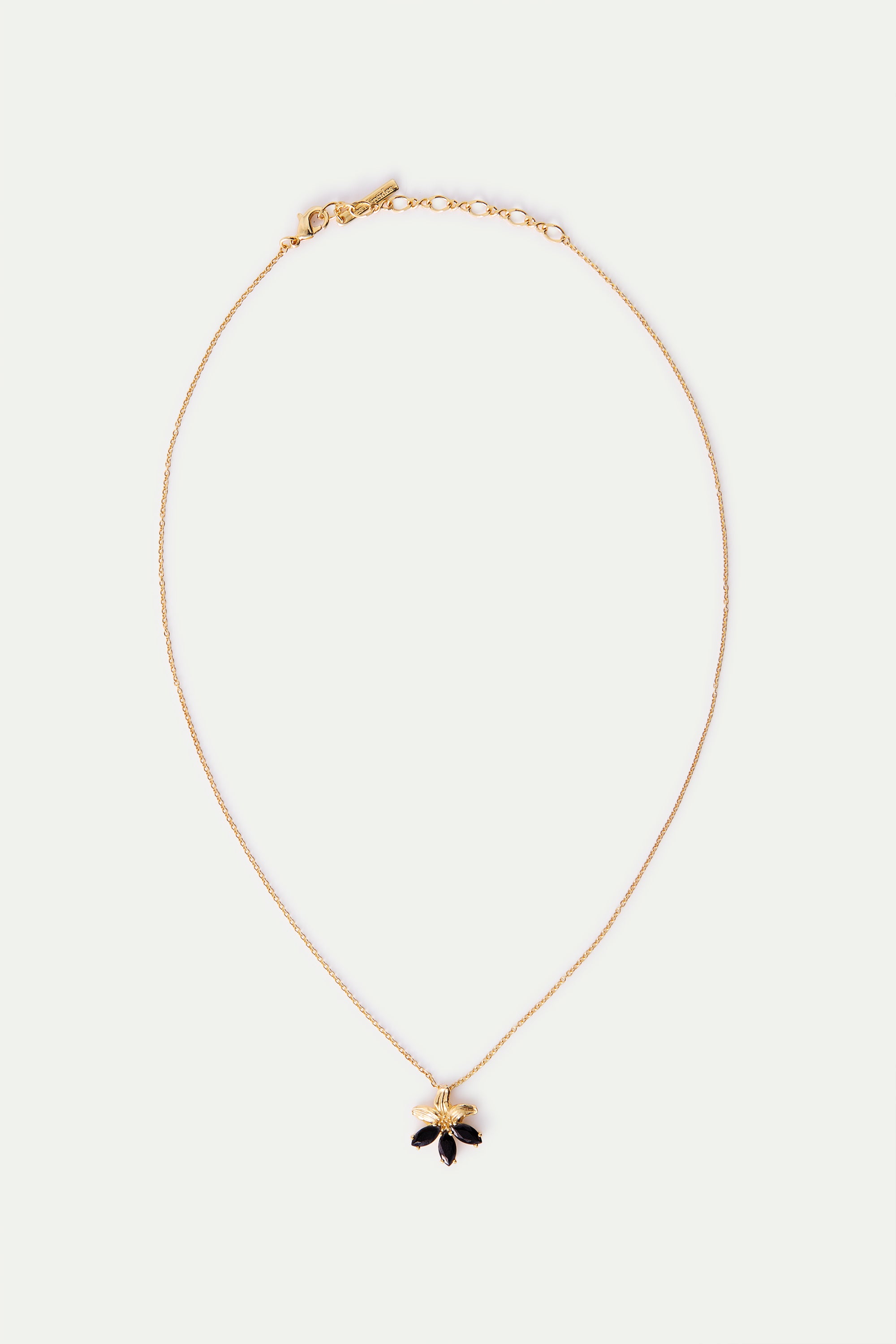 Golden lily and black stone pendant necklace