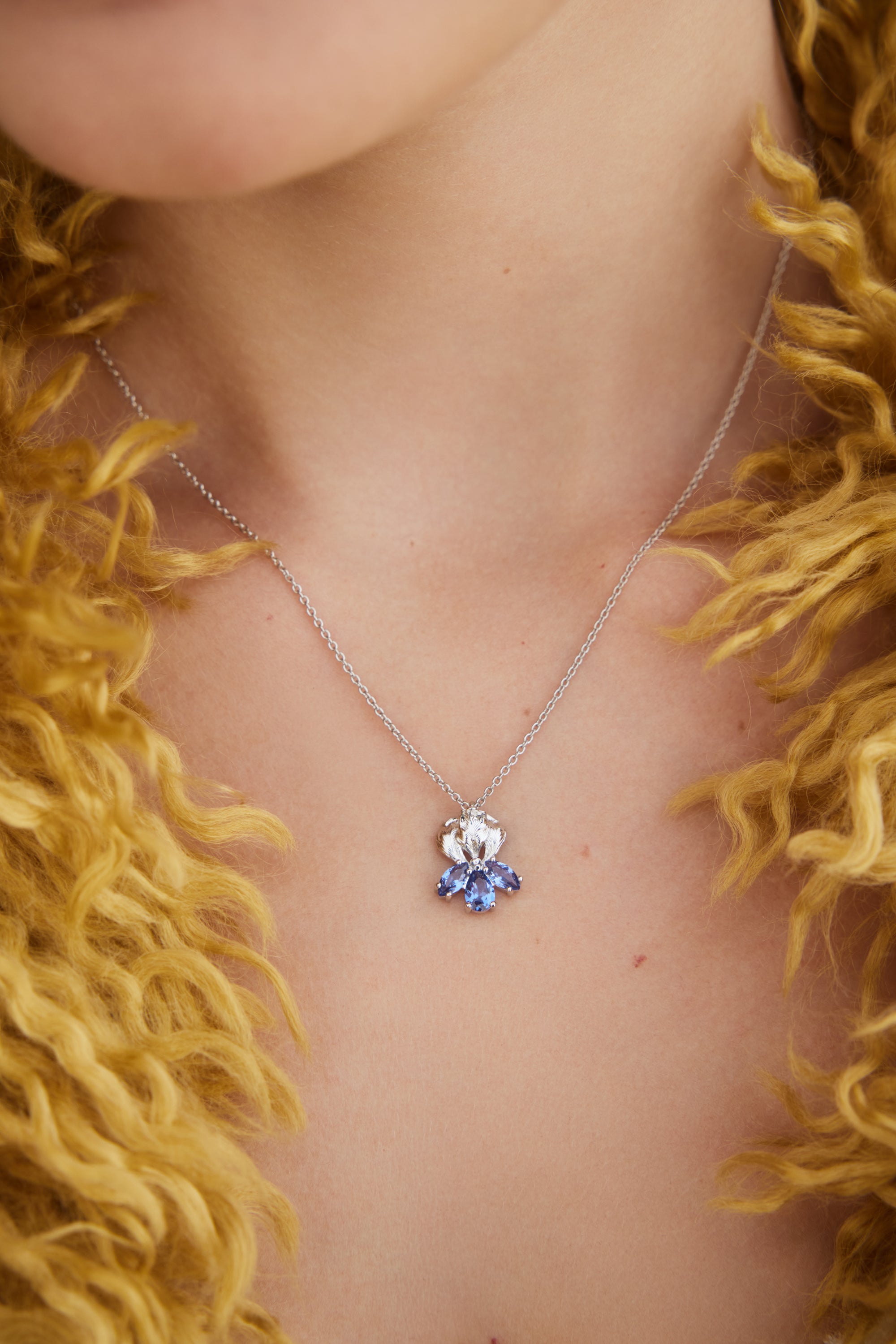 Silver iris and blue stone pendant necklace